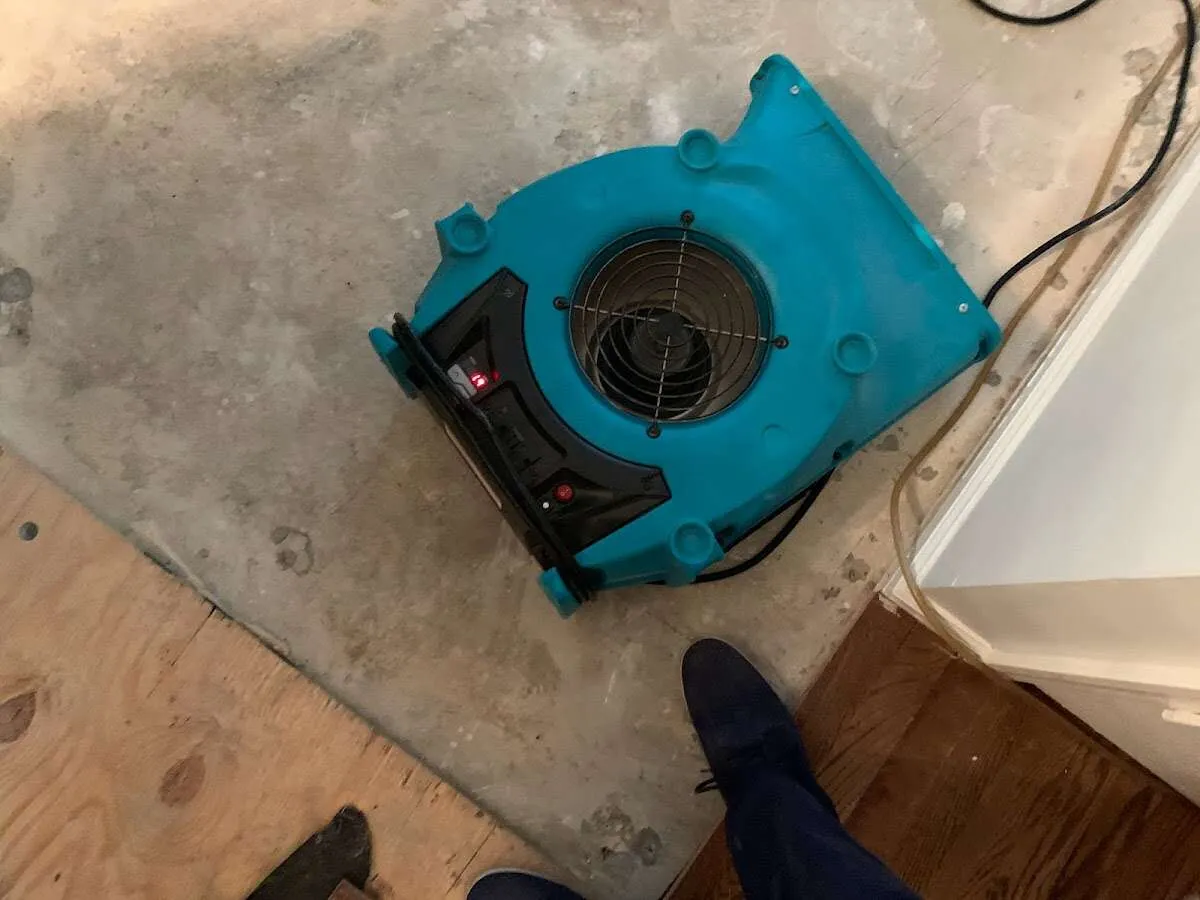 Air mover drying subfloor during Commercial Water Damage Restoration in Jersey Village